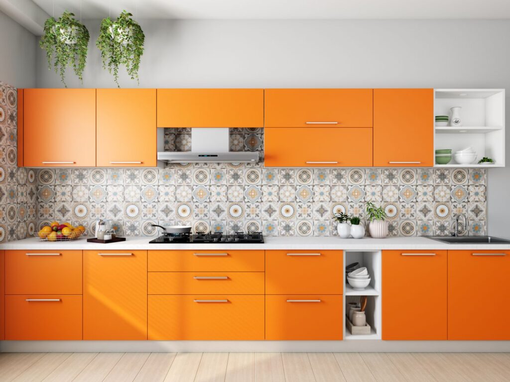 Vibrant orange kitchen with patterned tile backsplash and modern decor elements.