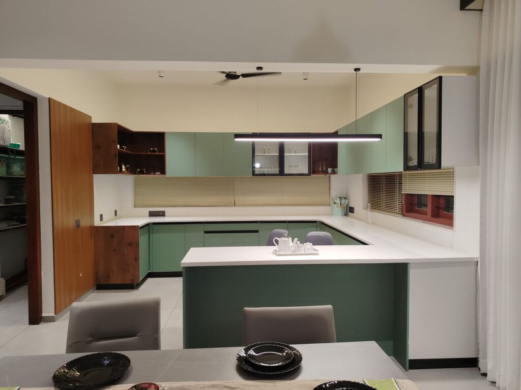 Stylish modern kitchen featuring green cabinets and minimalist design.