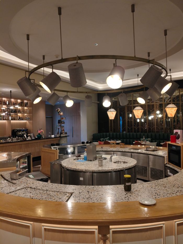 Chic restaurant interior featuring modern lighting and a well-designed bar area.