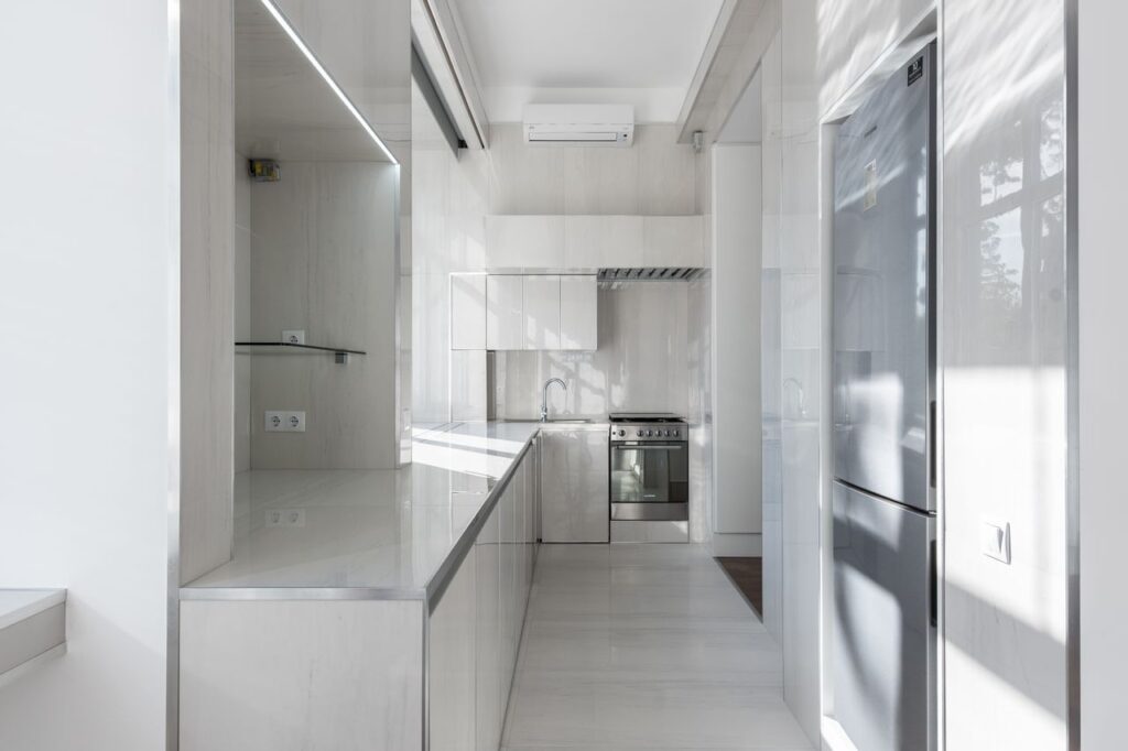 Bright and modern kitchen interior with minimalist design and sleek appliances.